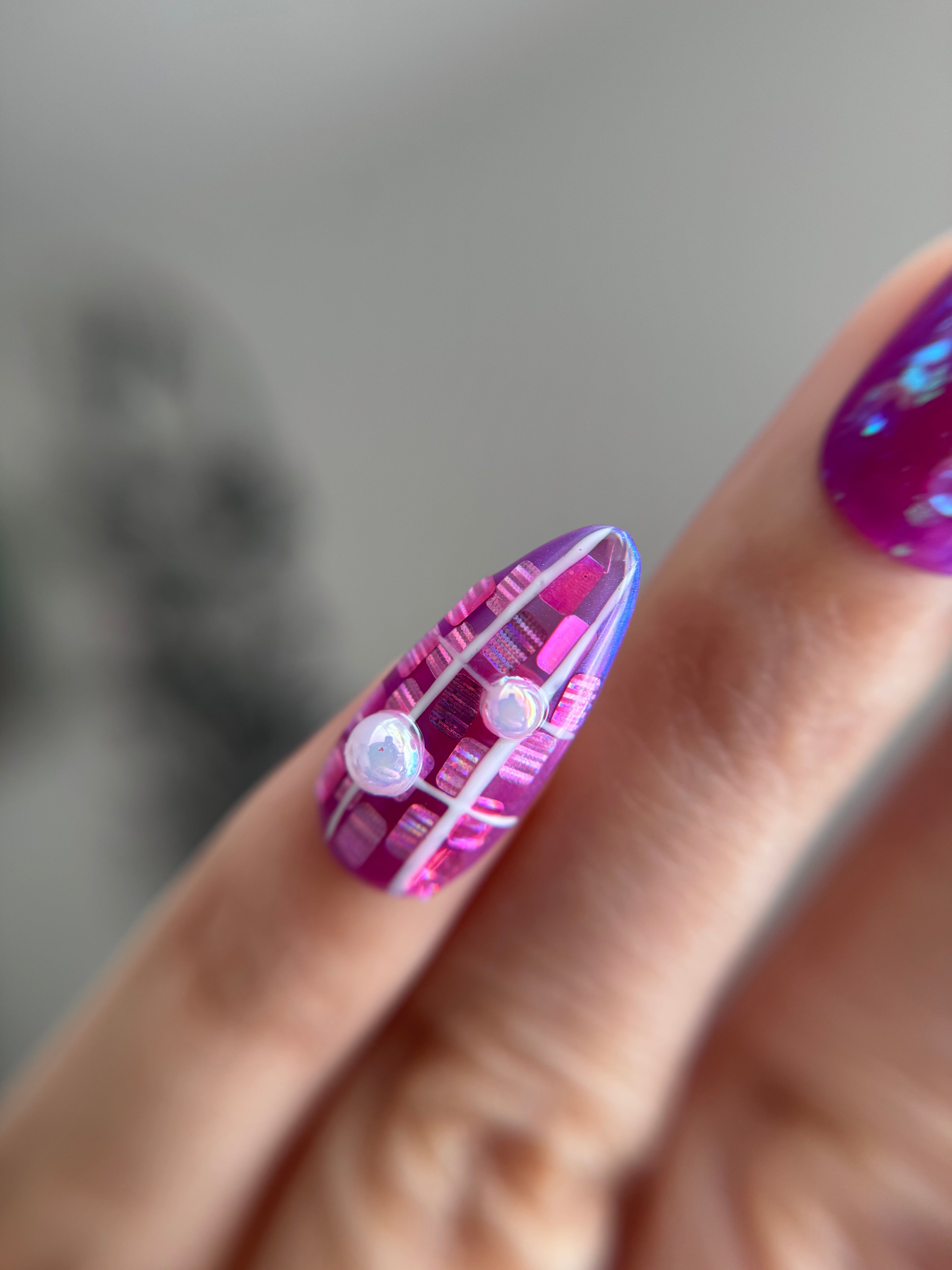 Violet Reverie purple iridescent handmade press-on nails with floral art and crystal details worn on hand