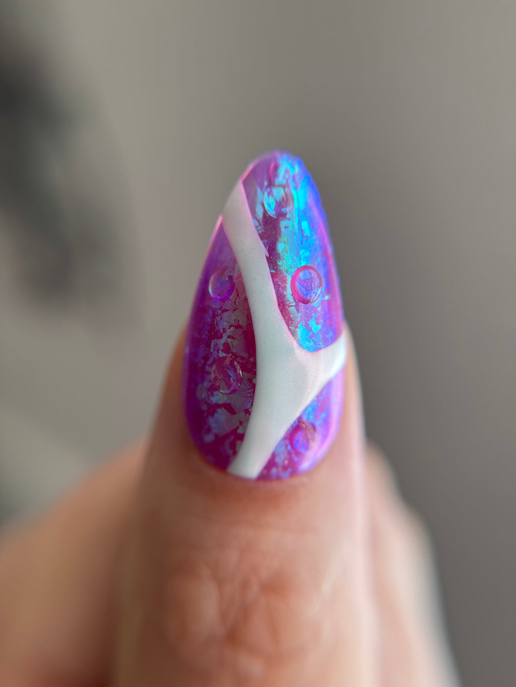 Violet Reverie purple iridescent handmade press-on nails with floral art and crystal details worn on hand