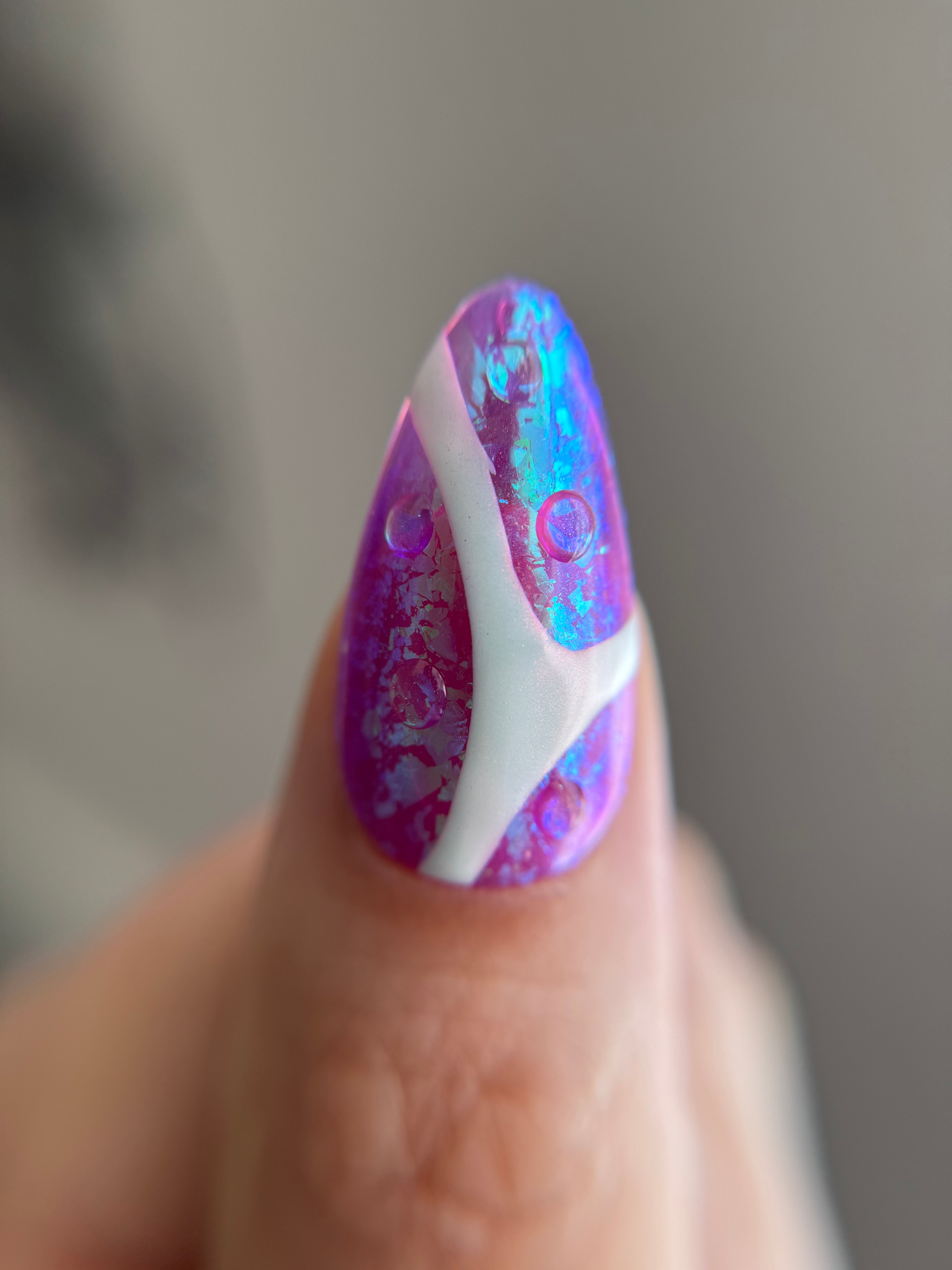 Violet Reverie purple iridescent handmade press-on nails with floral art and crystal details worn on hand