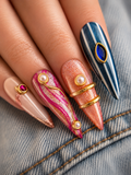 Luxury handmade colorful gel press-on nails with gold metallic details, pearls, gemstones, and artistic modern designs on a white background.