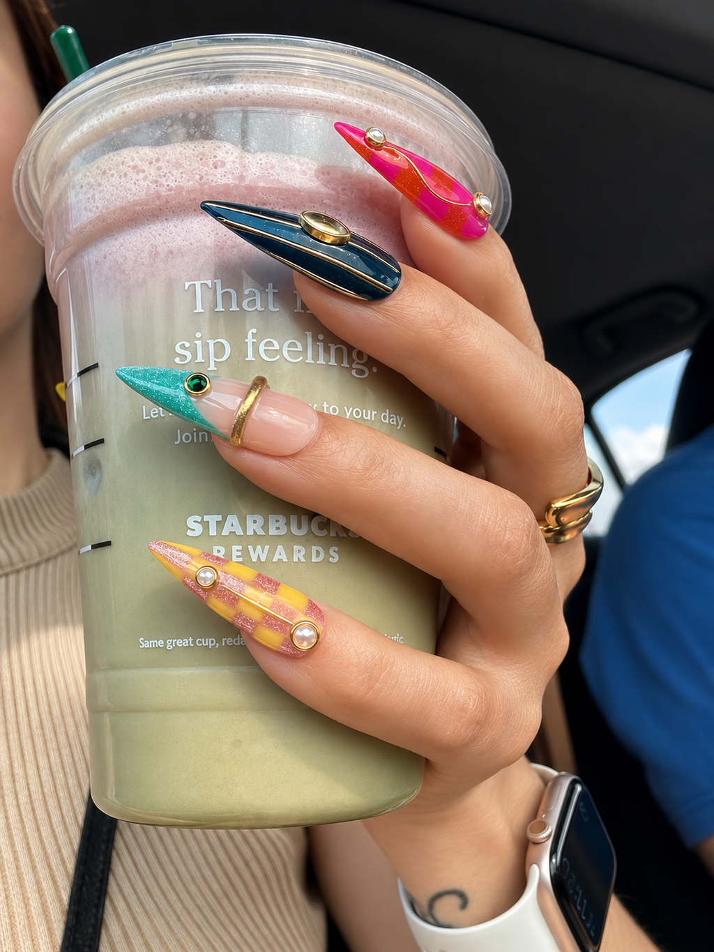 Fashion-inspired luxury press-on nails styled in a modern lifestyle setting with colorful artistic nail designs.